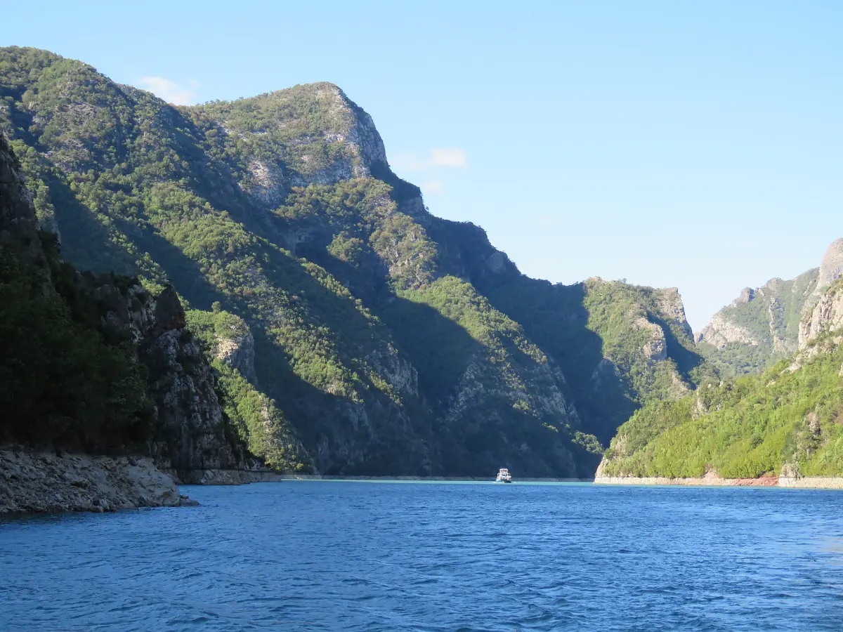 A ferry between the cliffs of Lake Komani