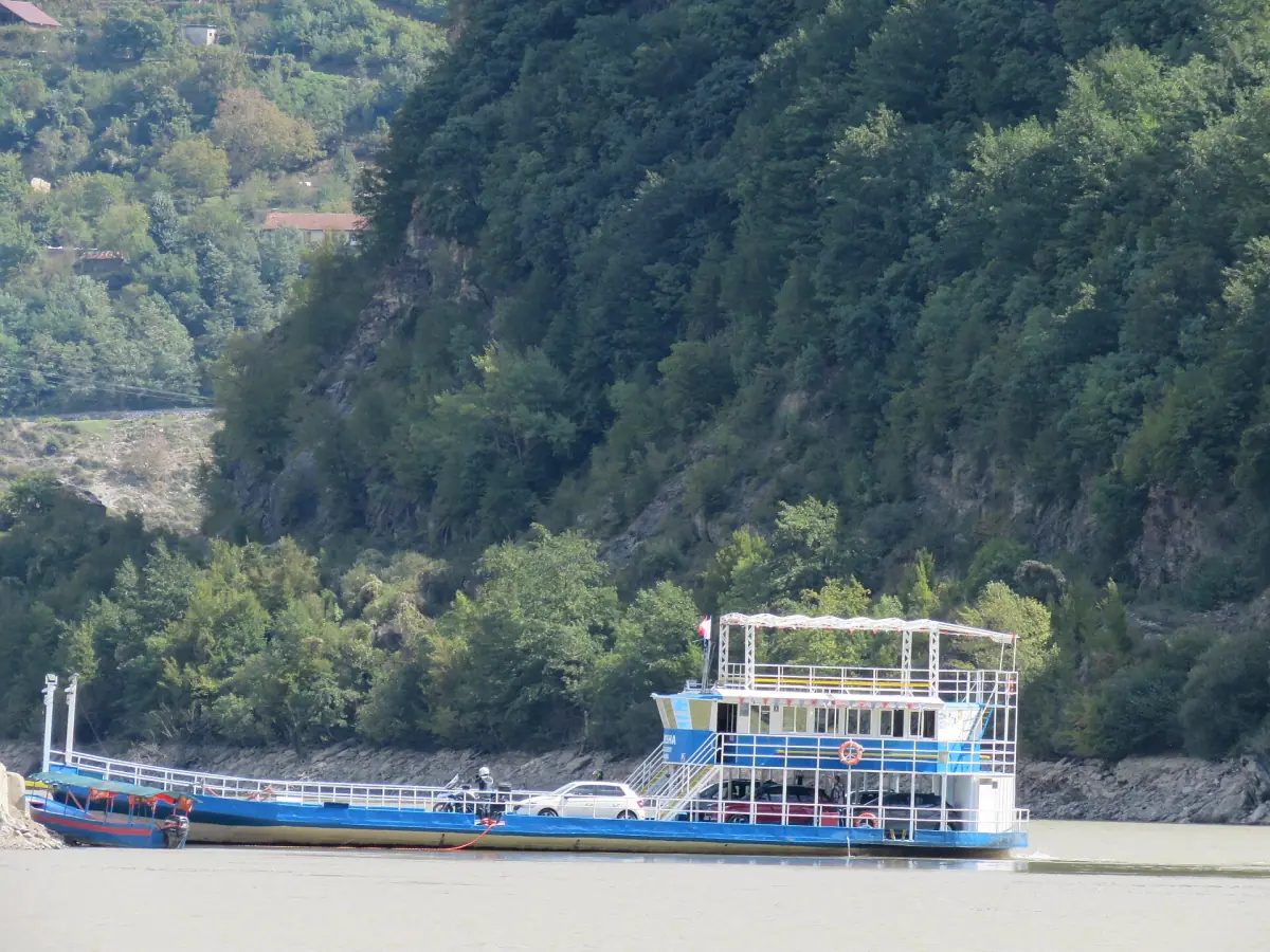 A ferry near the shore of Lake Komani