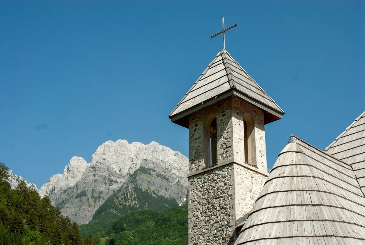 Il campanile della chiesa di Theth ai piedi delle montagne